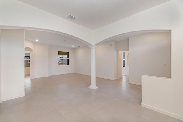 empty room featuring decorative columns