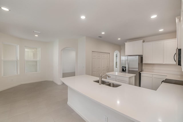 kitchen with sink, stainless steel appliances, white cabinets, and a kitchen island