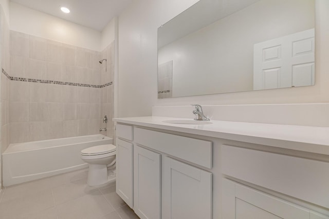 full bathroom with tiled shower / bath, vanity, tile patterned floors, and toilet