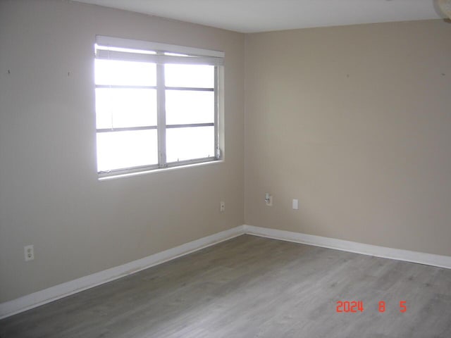 empty room featuring baseboards and wood finished floors