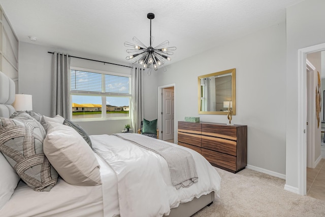 carpeted bedroom with an inviting chandelier and a textured ceiling