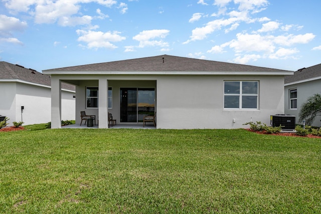 back of house with a lawn, a patio area, and central air condition unit