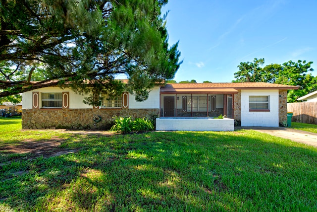 ranch-style home featuring a front yard