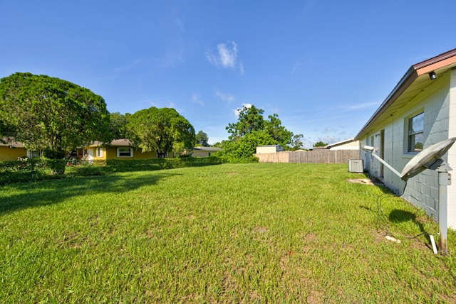 view of yard featuring cooling unit and fence