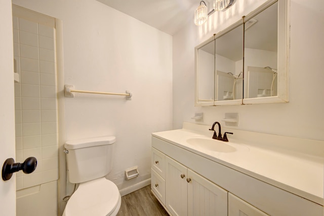 bathroom with vanity, hardwood / wood-style flooring, and toilet