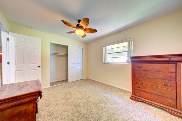 bedroom with a closet, light colored carpet, and ceiling fan