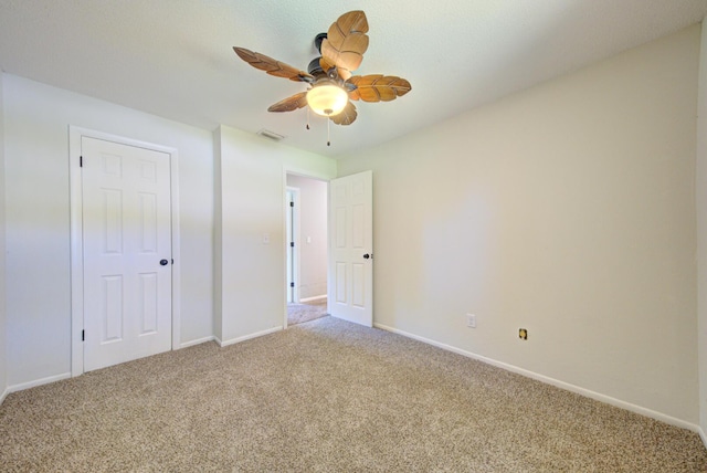 unfurnished bedroom featuring ceiling fan, carpet floors, visible vents, and baseboards