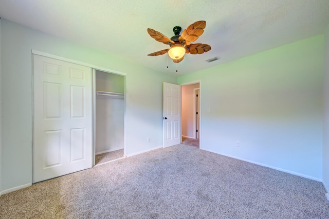 unfurnished bedroom featuring ceiling fan, carpet flooring, and a closet