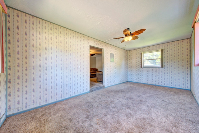 spare room featuring light carpet, a textured ceiling, and ceiling fan