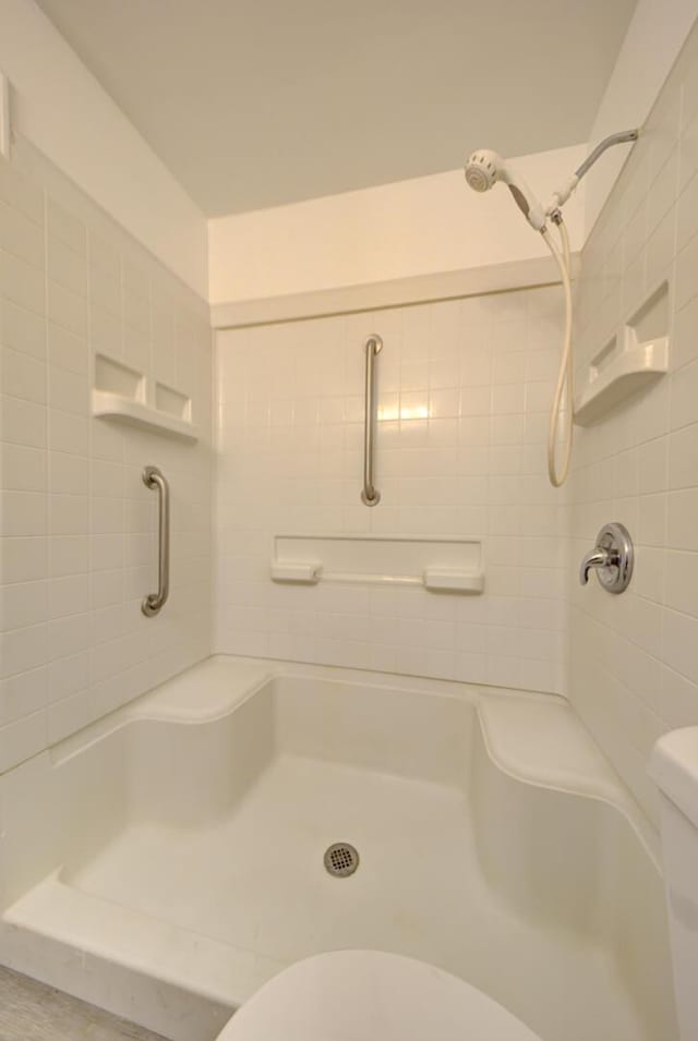 bathroom featuring toilet and walk in shower