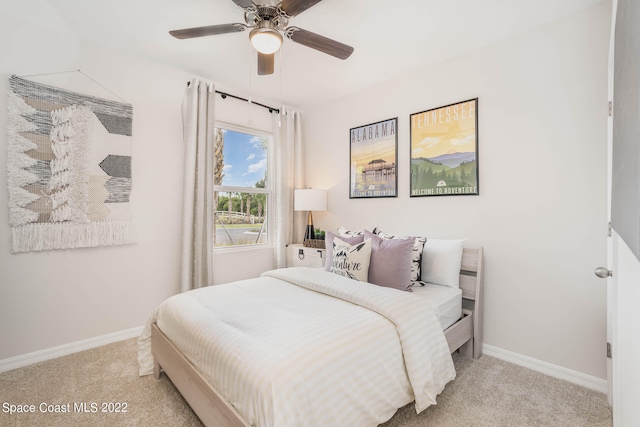 bedroom featuring light colored carpet and ceiling fan