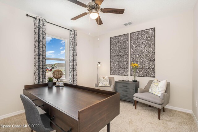 carpeted home office with ceiling fan