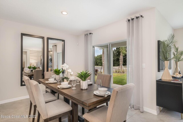 dining area featuring light tile patterned flooring