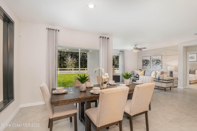 tiled dining area featuring ceiling fan