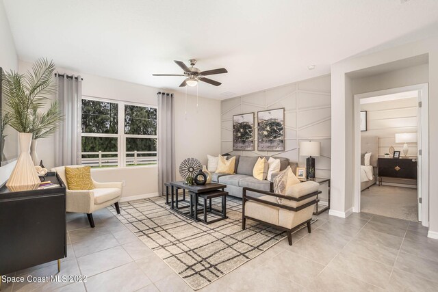 living room featuring ceiling fan and light tile patterned floors