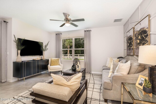 tiled living room with ceiling fan