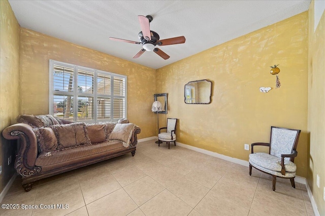 living area featuring ceiling fan and light tile patterned flooring