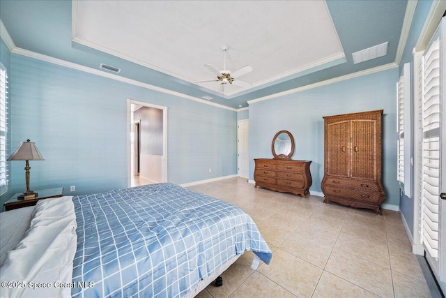 tiled bedroom with a raised ceiling, crown molding, ceiling fan, and multiple windows