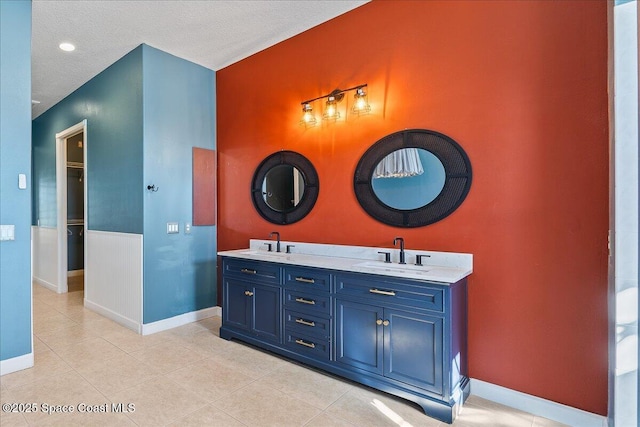 bathroom featuring tile patterned floors, vanity, and a textured ceiling