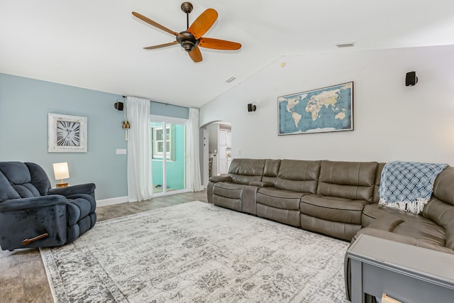 living room featuring vaulted ceiling, ceiling fan, and light wood-type flooring