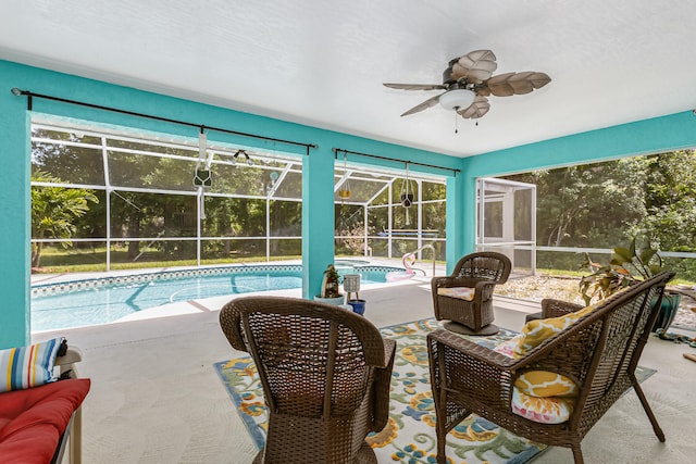 exterior space with an outdoor hangout area, a patio, ceiling fan, and glass enclosure