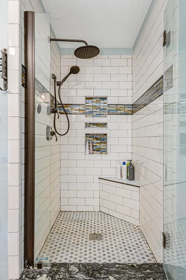 bathroom featuring a shower with door