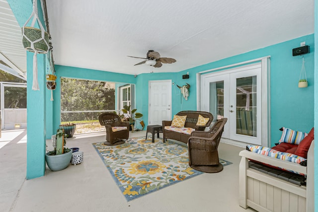 sunroom / solarium featuring french doors and ceiling fan