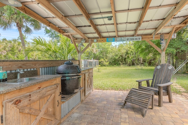 view of patio featuring area for grilling and sink