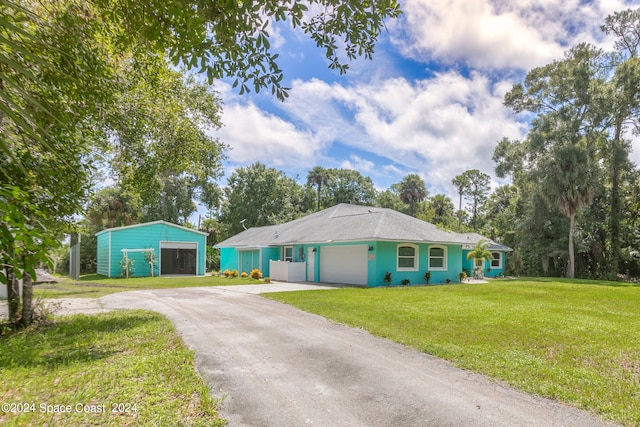 single story home with a front yard and a garage