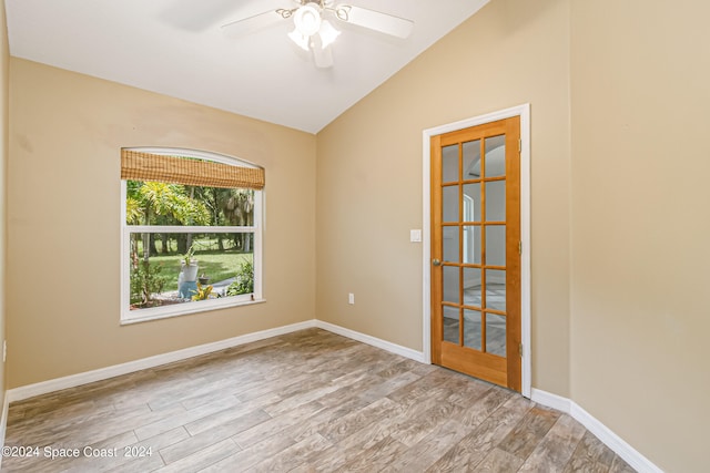 spare room with lofted ceiling, light hardwood / wood-style flooring, and ceiling fan