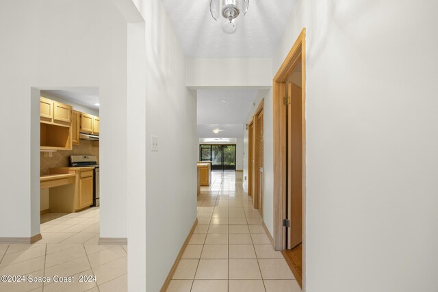 hall featuring light tile patterned floors