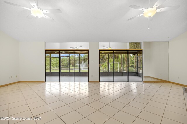 empty room featuring light tile patterned floors and ceiling fan