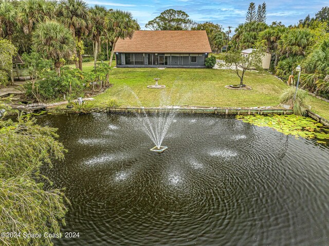 exterior space featuring a water view and a lawn