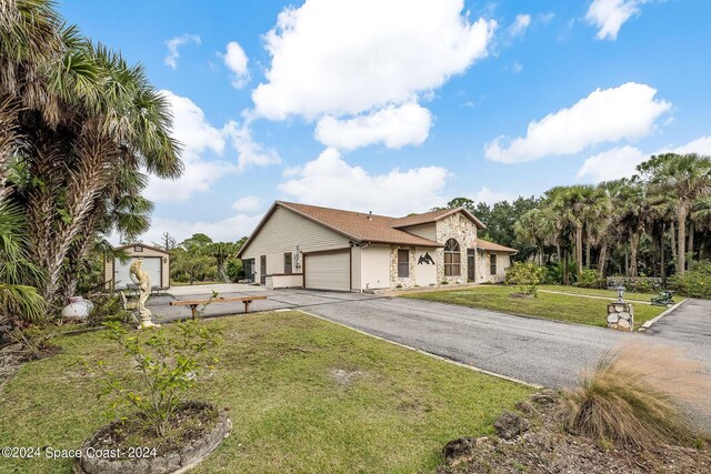 view of front facade with a garage and a front lawn