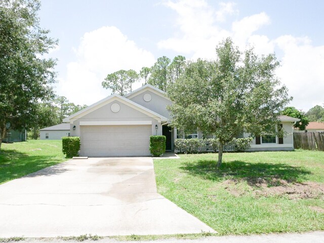 view of front of home with a garage and a front lawn