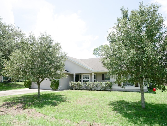 ranch-style home with a garage and a front yard