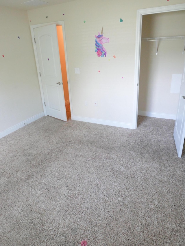 unfurnished bedroom with carpet, baseboards, and a closet