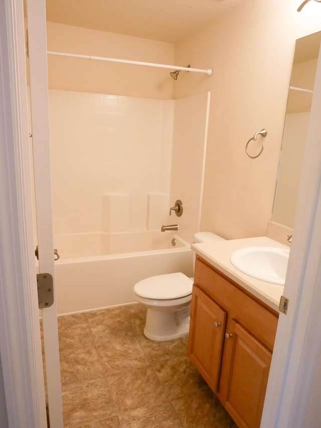 bathroom with toilet, bathing tub / shower combination, and vanity