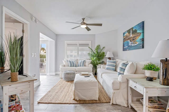 living room featuring light hardwood / wood-style flooring and ceiling fan