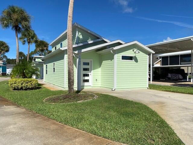 view of side of property with a yard