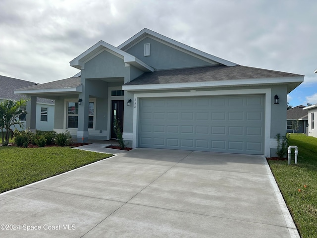 view of front facade with a garage and a front yard