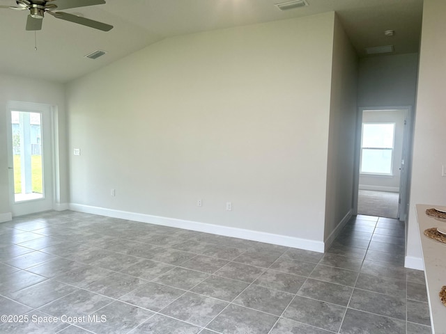 858 Soleway Dr, Palm Bay, FL 32907 - tiled spare room featuring vaulted ceiling, healthy amount of natural light, a ceiling fan, and baseboards