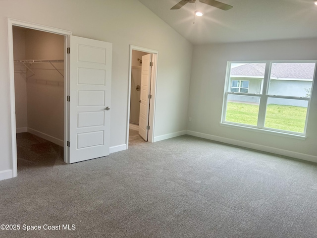 858 Soleway Dr, Palm Bay, FL 32907 - unfurnished bedroom with a walk in closet, carpet flooring, vaulted ceiling, baseboards, and a closet