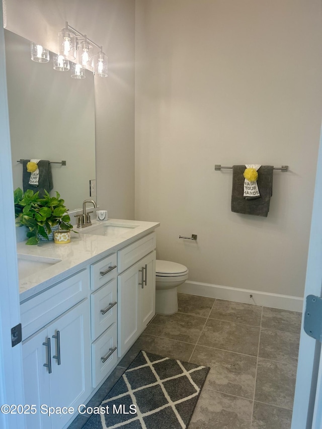 858 Soleway Dr, Palm Bay, FL 32907 - bathroom with double vanity, toilet, and baseboards