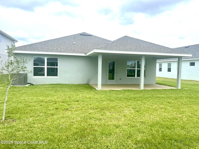 858 Soleway Dr, Palm Bay, FL 32907 - rear view of house featuring roof with shingles, a patio area, stucco siding, a lawn, and central air condition unit