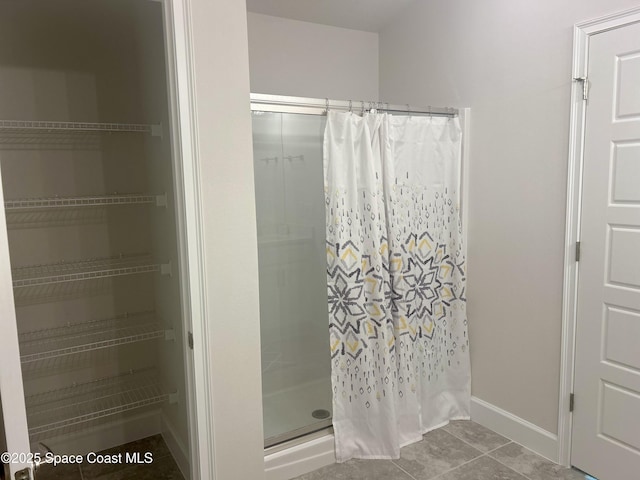 858 Soleway Dr, Palm Bay, FL 32907 - full bath with a shower with shower curtain, baseboards, and tile patterned flooring