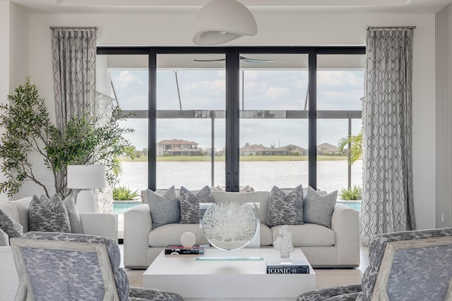 living room featuring light hardwood / wood-style floors and a water view