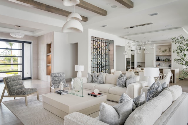 living room featuring a chandelier and light hardwood / wood-style flooring