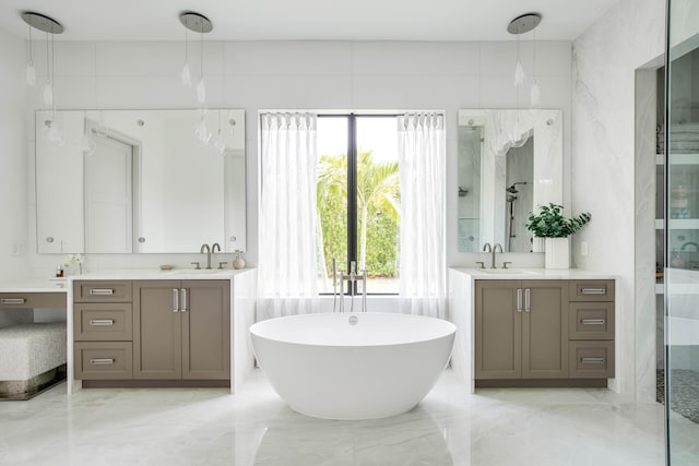 bathroom featuring double vanity, tile walls, a tub to relax in, and tile patterned floors