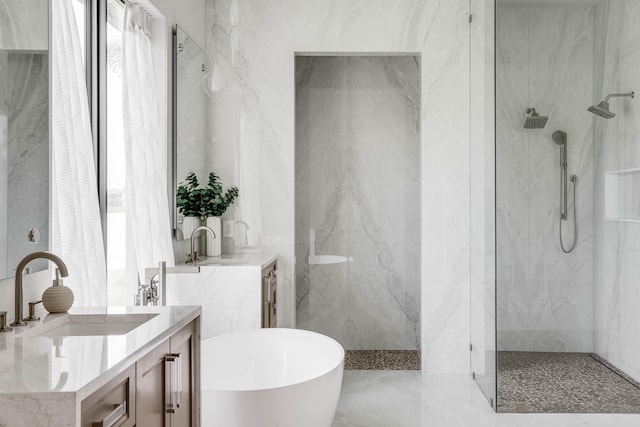 bathroom featuring vanity, tile walls, tile patterned floors, and separate shower and tub